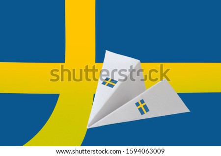 Sweden flag depicted on paper origami airplane. Handmade arts concept