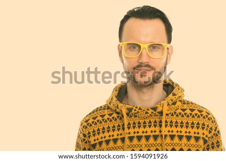 Studio shot of young man wearing yellow eyeglasses