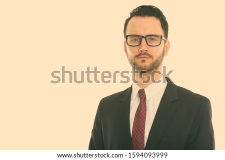 Studio shot of young businessman wearing eyeglasses