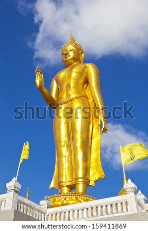 golden buddha against blue sky