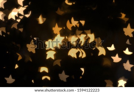 Compilation of many out of focus light giving a nice bokeh in the shape of a star, perfect Christmas background.