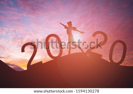 Silhouette of people jump with the sun of New year 2020 concept.