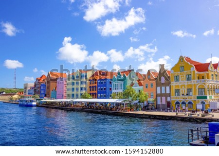 Specific coloured buildings at street in Curacao Royalty-Free Stock Photo #1594152880