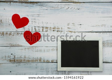 Valentine's Day! Beautiful white wooden background with decor photo frame and red hearts. Best Valentine's Day Greeting Card. I love you