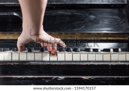 Female pianist hands playing on old piano keyboard. Background with selective focus. Vintage retro instrument