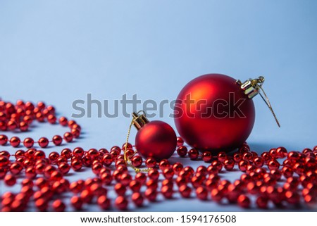 Christmas and New Year holiday card with festive red balls on a classic light blue background, space for text