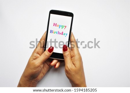 Colorful text happy birthday on smartphone women hands holing isolate on white photo