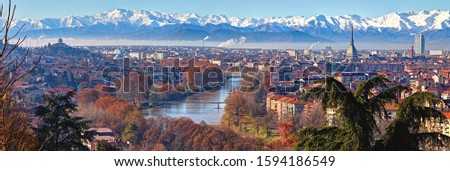 Panoramic view on Turin skyline, with the city center, Po river and Mole Antonelliana, in a clear winter morning with snowy alps on background Royalty-Free Stock Photo #1594186549