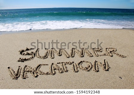 Summer Vacation. The word SUMMER VACATION written in the sand on the beach. Laguna Beach California. Words written in sand.