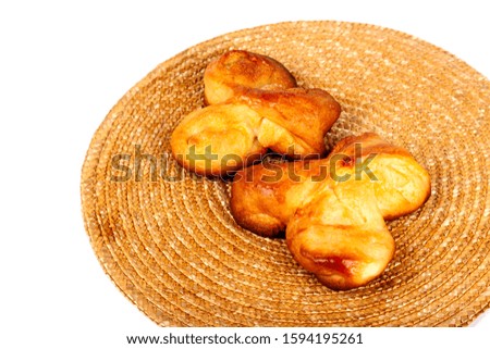 Two simple fresh homemade sweet buns isolated on white, dessert, closeup. Pair of bread rolls on an organic natural brown mug pad. Baking healthy tasty food at home, tea snack concept food photography