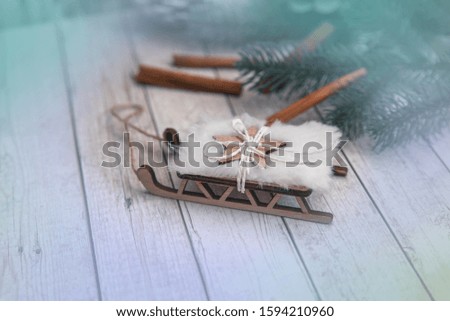 Christmas background with toys, balls, cinnamon, sprigs of Christmas tree and sled. Place for text