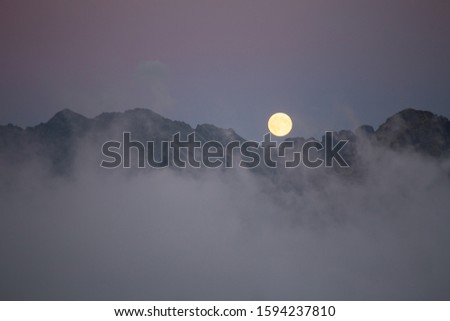 Moon over the clouds. Tatry
