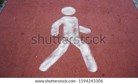 a pedestrian sign, road, walking path