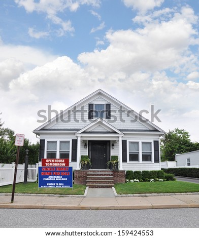 For Sale Sign Front Yard Lawn Suburban Bungalow Cottage Style Home Residential Neighborhood USA blue sky clouds