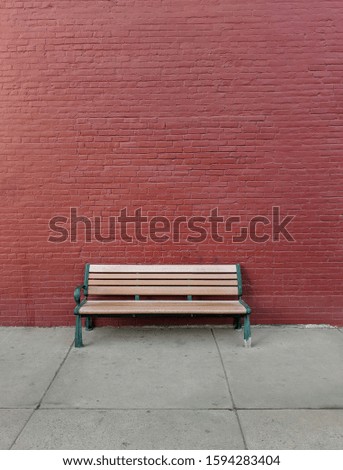 Empty bench along a brick wall.  