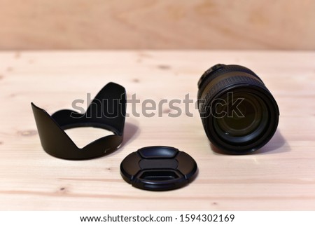 Camera Lens on Wooden Table