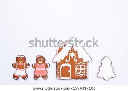 The hand-made eatable gingerbread house, little men on white background