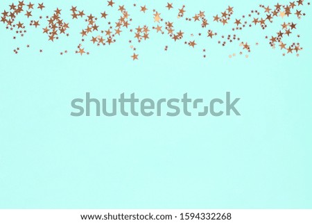 Frame from golden stars glitter confetti on blue background. Gold sparkles texture. Holiday new year backdrop. Anniversary, birthday. Greeting card template.