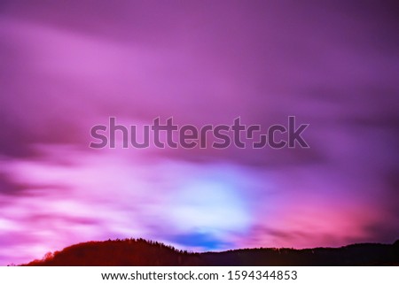 Colorful winter night with clouds.
