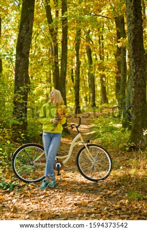 Weekend activity. Active leisure and lifestyle. Girl ride bicycle for fun. Blonde enjoy relax forest. Autumn bouquet. Warm autumn. Girl with bicycle and flowers. Woman with bicycle autumn forest.