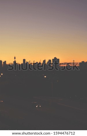 Silhouette of Sydney skyline at sunset of orange and purple sky
