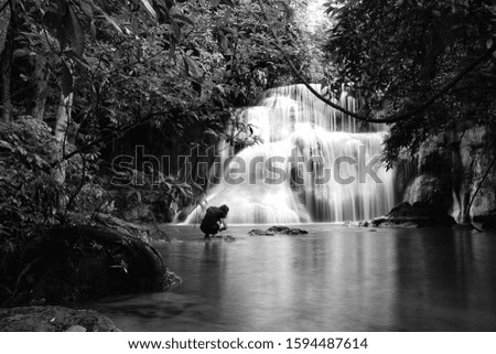 Beautiful waterfall with people trying to take pictures
