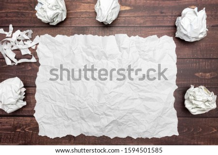 top view of a sheet of white wrinkled paper and crumble paper balls. inspiration, creativity and Business workplace Concept. space for text