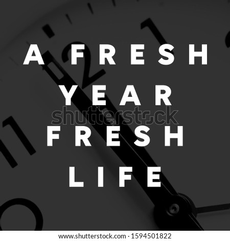Happy new year quote; A fresh year, fresh life. Black background.