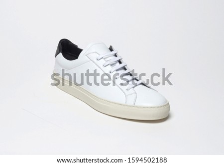 White casual sneakers with white base and white background