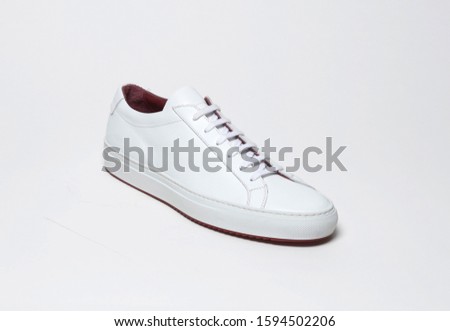 White casual sneakers with white base and white background