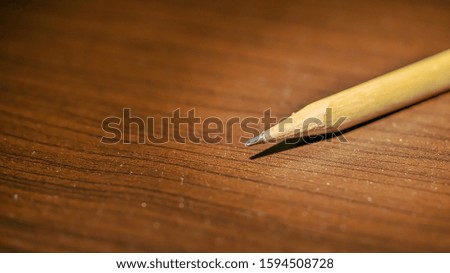 Pencil on top of wooden table abstract , Pencil on wooden table shallow depth , Pencil and bokeh macro photography