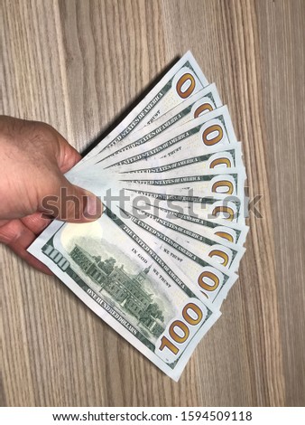 Buy 100 dollar American dollars and obtain on wooden table different alternative compositions angles perspective finance economy money market bank stock market finance world market.