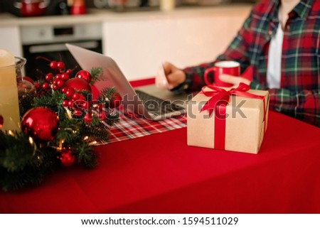 Millennial adult man makes holiday gifts online shopping on laptop. Merry Christmas and Happy New Year
