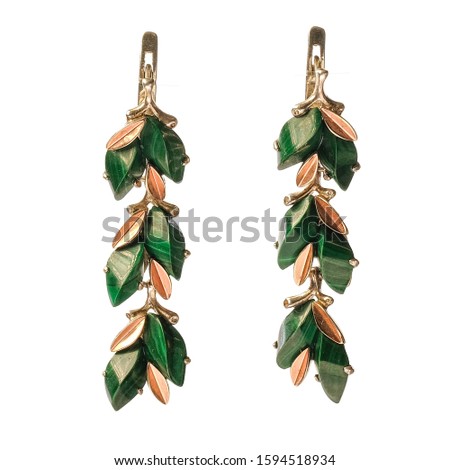 Women's jewelry. Gold earrings in the shape of petals with green malachite.