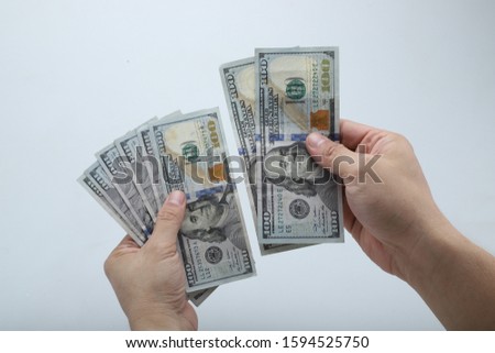 Fan of money in female hands isolated on white