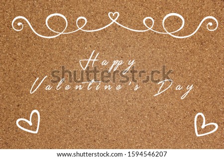 handwritten happy valentine's day lettering in white color on cork board
