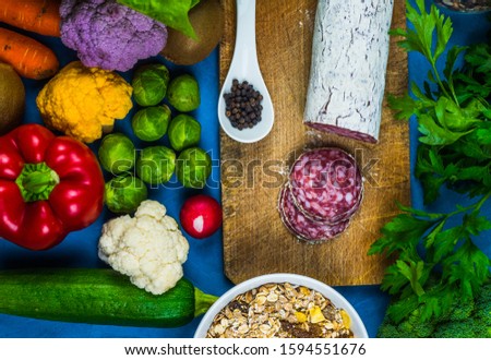Food sources on the blue synta with a view of the top of the space for copying. Products with high content of fatty acids, including vegetables, seeds, Italian salami. Fitness for healthy eating