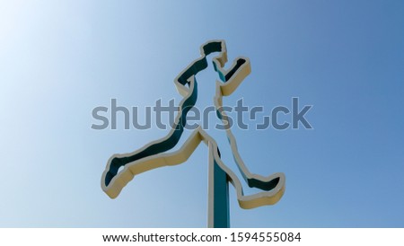 solated running man on blue sky background represent sport activity and healthy lifestyle