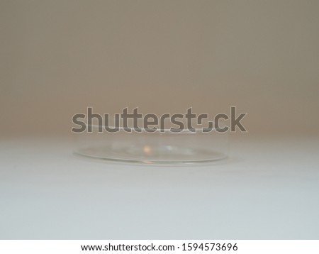 A Petri dish (alternatively known as a Petri plate or cell-culture dish) is a shallow transparent lidded dish that biologists use to culture cells such as bacteria, or small mosses.