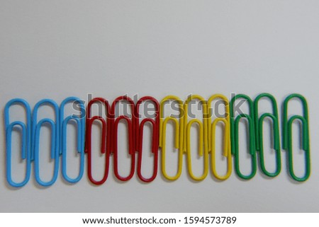 color paper clip on white background. macro focus