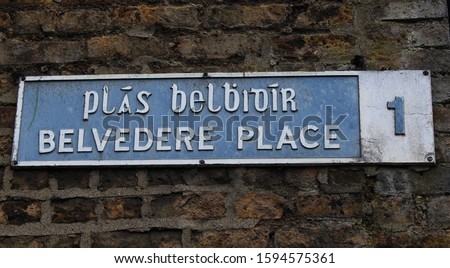 Belvedere Place in Dublin 1 street sign in English and translated into the Irish language, on a brick wall in Dublin. 
