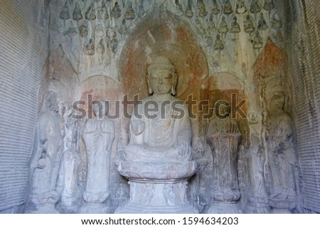 Wanfo cave, meaning thousands of Buddha, with 15,000 small Buddha carved differently on the wall of cave in west hill of Longmen Grottoes Luoyang China 
