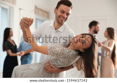 Lovely young couple dancing together at party