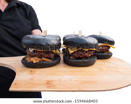 Serving Black Bread Cheeseburger on wooden bread