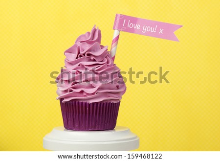 Valentine cupcake on yellow background