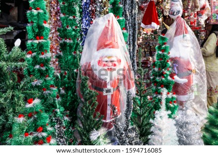 New year fair,Big sale of Christmas trees and Santa doll. Sale of artificial fir trees and festive decorations in tents
