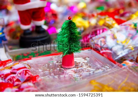 New year fair, Big sale of Christmas trees and Santa doll. Sale of artificial fir trees and festive decorations in tents. Merry Christmas and Happy New Year 2020.
