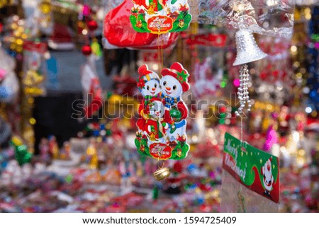 New year fair, Big sale of Christmas trees and Santa doll. Sale of artificial fir trees and festive decorations in tents. Merry Christmas and Happy New Year 2020.