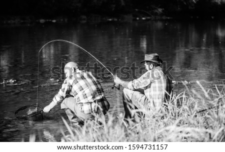 spend time together. fly fish hobby of men. retirement fishery. happy fishermen friendship. big game fishing. relax on nature. retired father and mature bearded son. Two male friends fishing together.