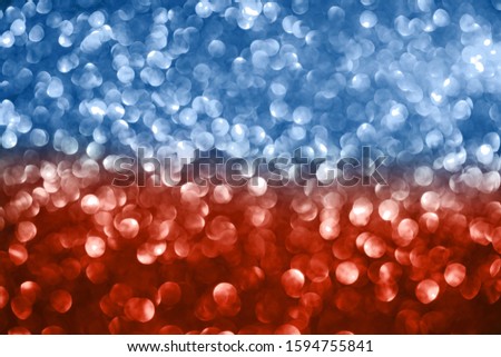 Abstract blue and coral defocused bokeh glitter sparkle confetti burst background. Festive concept.